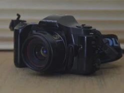 Boxed Olympus 101 With 50mm F2 PF Lens. A Beautiful Modern SLR Camera. All The Functions Of Digital In A Analogue Camera. Amazing Quality